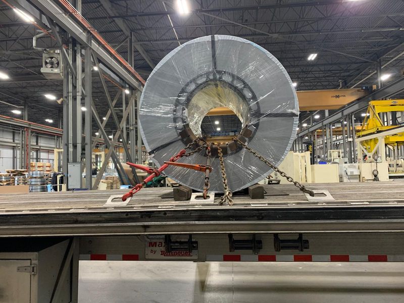 Steel coil chained on a Fission trailer inside a plant