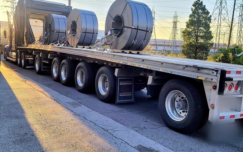 Steel coils on a Fission trailer at sunset