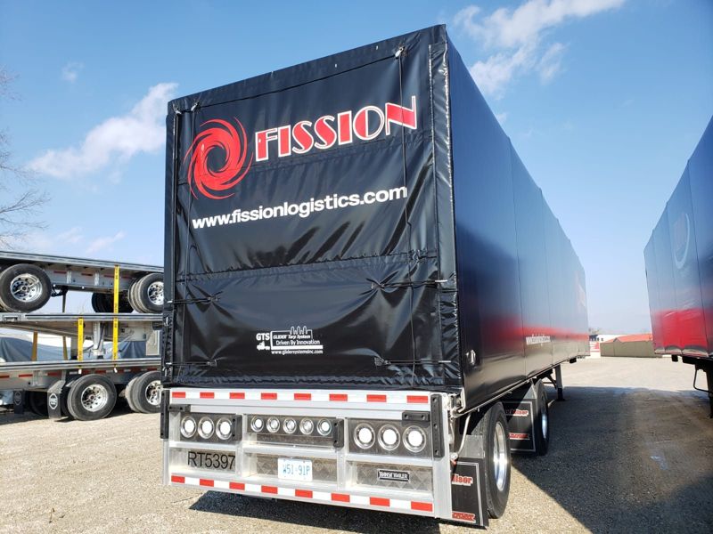 Fission Conestoga trailer on gravel in the yard