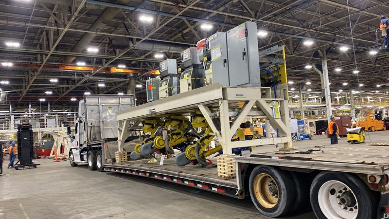 A production cell riding low on a Fission double drop trailer inside a plant