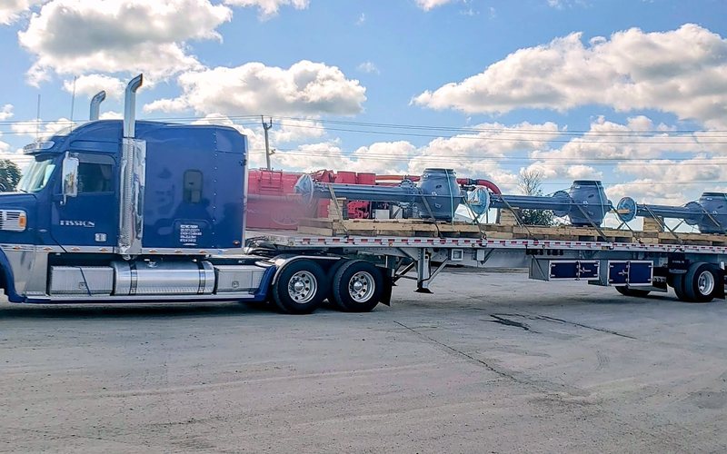 Fission step deck trailer loaded with machinery