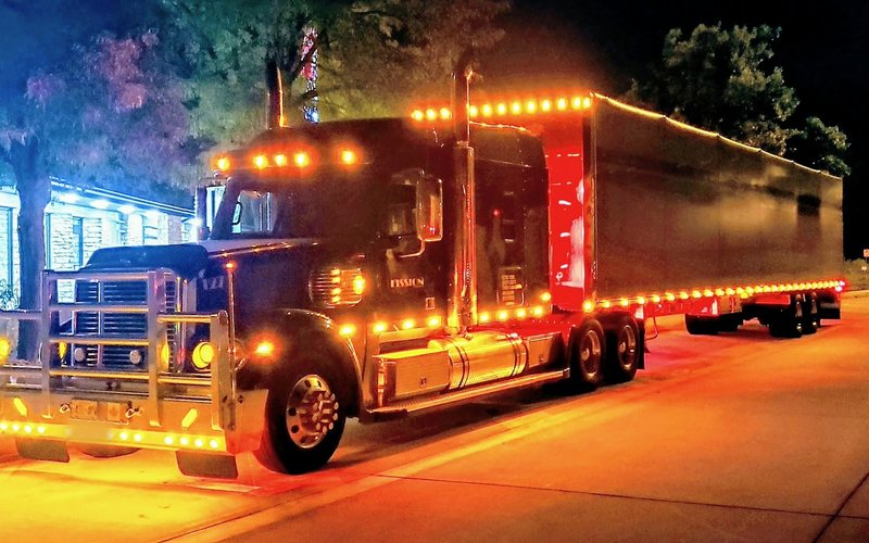 Fission tractor and Conestoga lit up at night