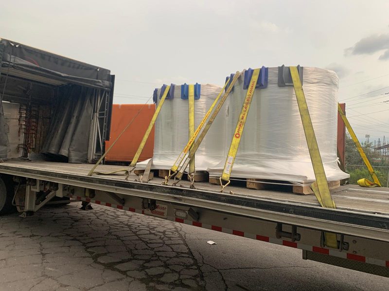 Two wrapped pallets strapped on a Fission Conestoga, curtain open