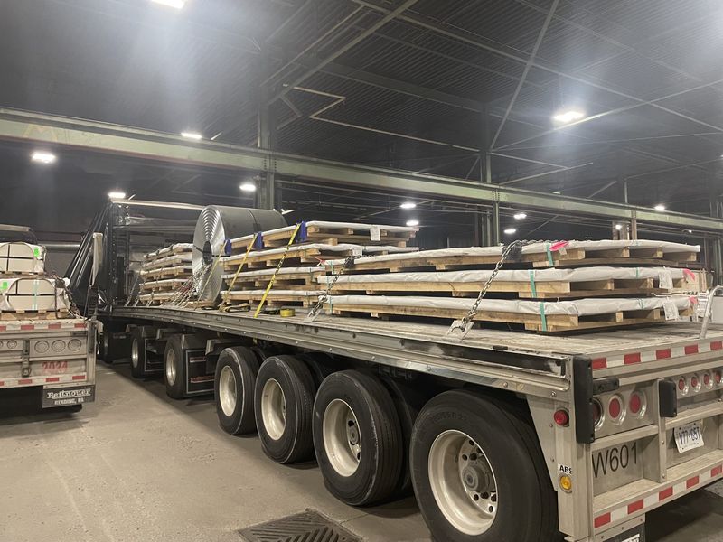 Steel plate on skids, strapped and chained on a Fission trailer