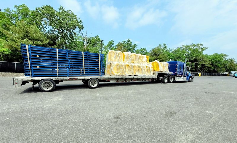 Steel racking and wrapped building materials on a Fission flatbed